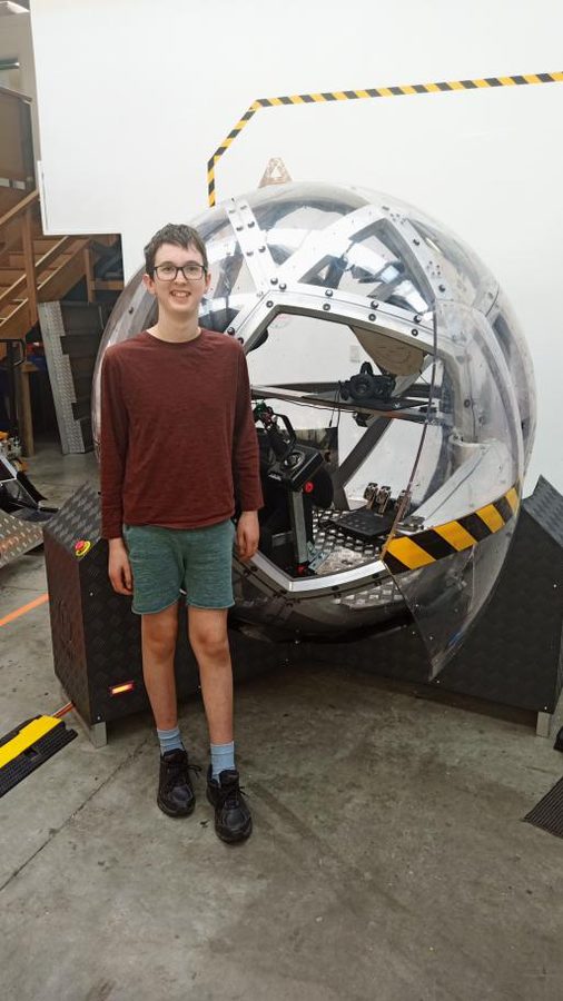 Tom beside a spherical motion simulator at the Space & Science Festival